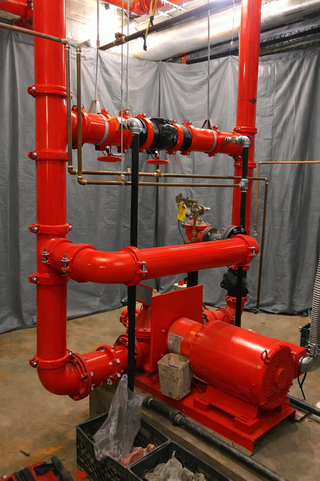 Red fire pump and piping installation by USA Fire Sprinklers